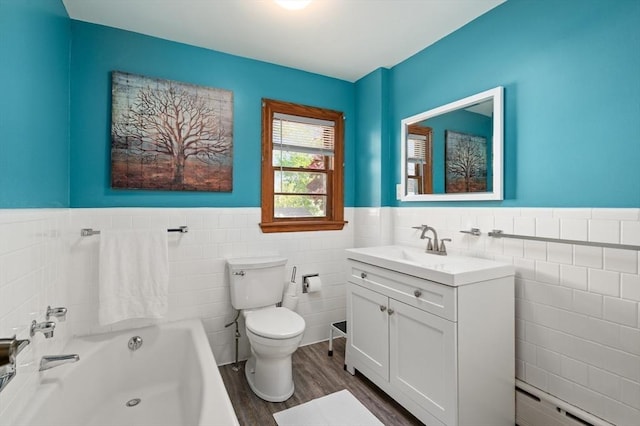 58 Spring St, Wakefield, MA 01880 - bathroom featuring tile walls, wood finished floors, wainscoting, vanity, and toilet
