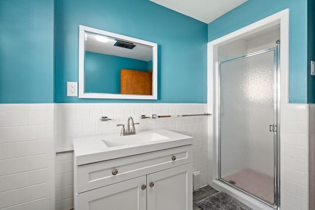 58 Spring St, Wakefield, MA 01880 - full bath with tile walls, a stall shower, wainscoting, and vanity