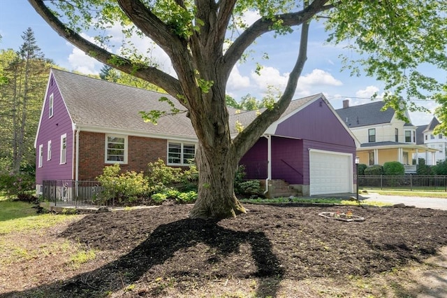 58 Spring St, Wakefield, MA 01880 - view of front of home with fence, concrete driveway, brick siding, and an attached garage