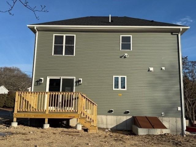 rear view of house featuring a wooden deck