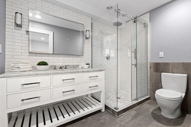 80 Worcester St Unit A, Boston, MA 02118 - bathroom featuring vanity, tile walls, a shower stall, and wainscoting