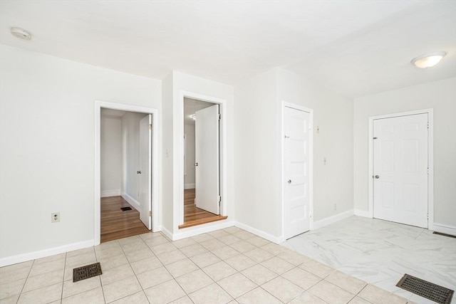 empty room with visible vents and baseboards