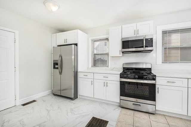 kitchen with visible vents, white cabinets, appliances with stainless steel finishes, and light countertops