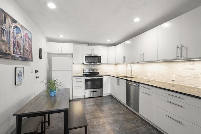 51 Warren St Unit 2-2, Waltham, MA 02453 - kitchen with a sink, recessed lighting, dark wood-style flooring, backsplash, and appliances with stainless steel finishes