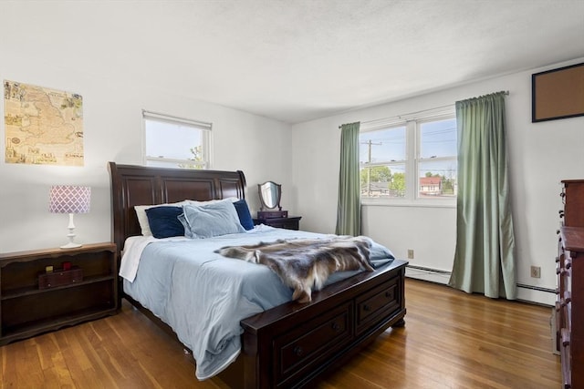 51 Warren St Unit 2-2, Waltham, MA 02453 - bedroom featuring a baseboard radiator and wood finished floors