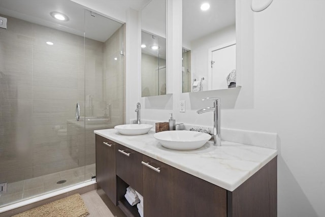 110 Stuart St Unit 24H, Boston, MA 02116 - full bathroom with double vanity, a stall shower, recessed lighting, and wood finished floors