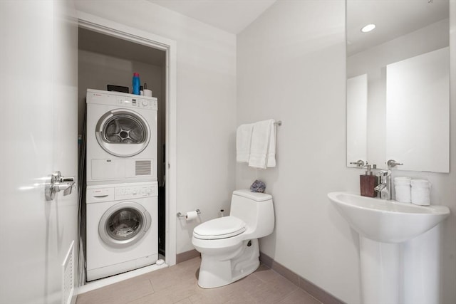 110 Stuart St Unit 24H, Boston, MA 02116 - bathroom with stacked washer / drying machine and toilet