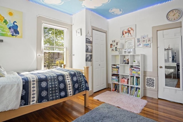 bedroom with wood finished floors and access to exterior