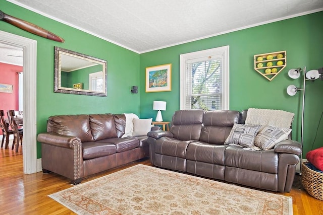 living area featuring ornamental molding and wood finished floors