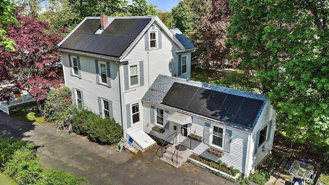 61 Mishawum Rd, Woburn, MA 01801 - view of front of property featuring entry steps, a chimney, a patio, a shingled roof, and view of wooded area