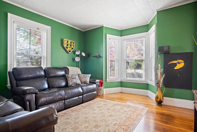 living room with ornamental molding, a healthy amount of sunlight, and wood finished floors