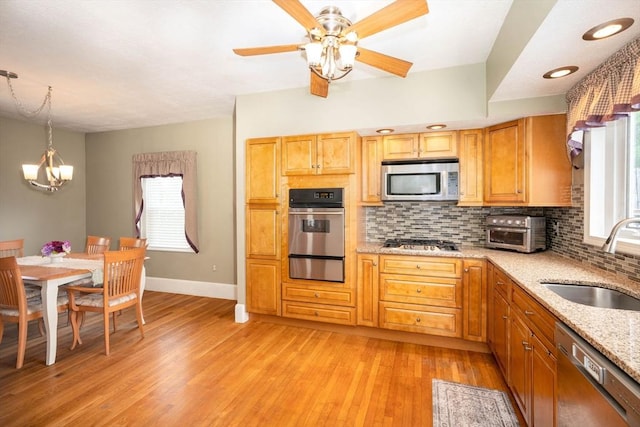 33 Samoset Ave, Quincy, MA 02169 - kitchen with appliances with stainless steel finishes, a sink, a warming drawer, decorative backsplash, and healthy amount of natural light