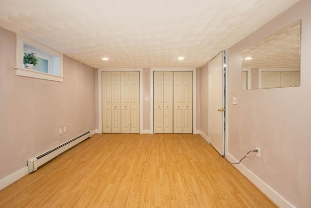 33 Samoset Ave, Quincy, MA 02169 - unfurnished bedroom with a baseboard radiator, multiple closets, light wood-type flooring, baseboards, and recessed lighting
