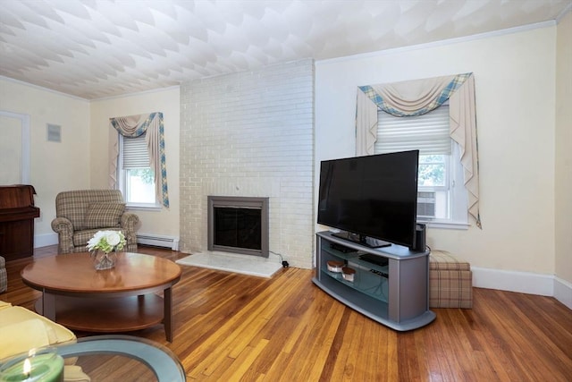 33 Samoset Ave, Quincy, MA 02169 - living area with a baseboard heating unit, ornamental molding, wood finished floors, a fireplace, and baseboards