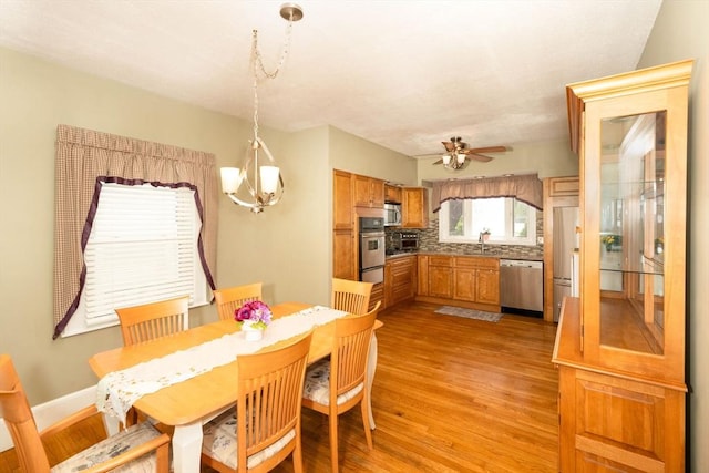 33 Samoset Ave, Quincy, MA 02169 - dining room with a chandelier, light wood-style flooring, ceiling fan, and baseboards
