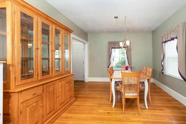 33 Samoset Ave, Quincy, MA 02169 - dining area featuring a chandelier, baseboards, and light wood-style floors