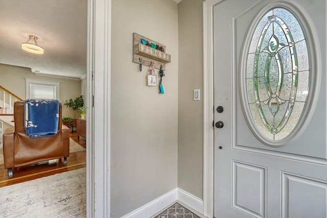 215 Curve, Dedham, MA 02026 - foyer entrance with baseboards, wood finished floors, ornamental molding, and stairway