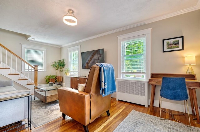 215 Curve, Dedham, MA 02026 - living area featuring stairs, radiator heating unit, wood finished floors, crown molding, and baseboards