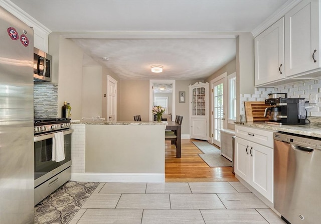 215 Curve, Dedham, MA 02026 - kitchen featuring stainless steel appliances, tasteful backsplash, and white cabinets