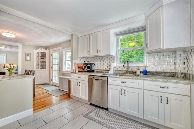 215 Curve, Dedham, MA 02026 - kitchen featuring stainless steel dishwasher, decorative backsplash, white cabinetry, and healthy amount of natural light