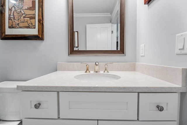 bathroom featuring ornamental molding and vanity