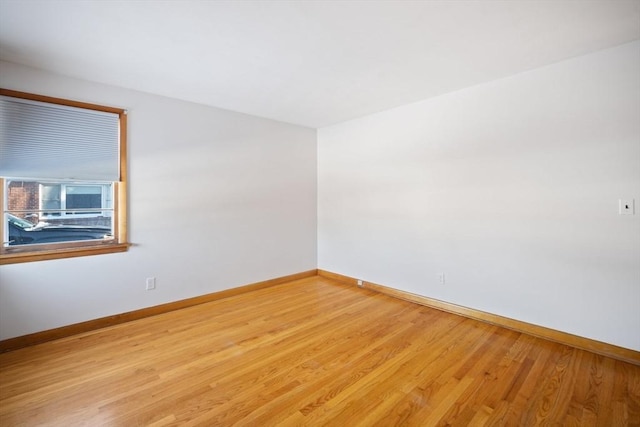 spare room with light wood-type flooring