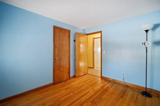 unfurnished bedroom with light wood-type flooring