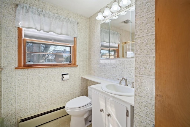 bathroom with a baseboard radiator, tile walls, tile patterned flooring, vanity, and toilet