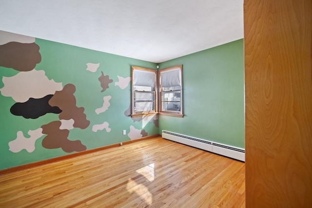 unfurnished room with wood-type flooring and baseboard heating