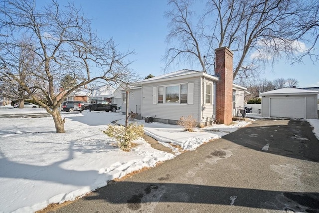 view of front of home featuring a garage and an outdoor structure