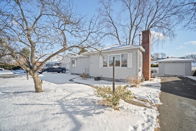 view of front of property with a garage and an outbuilding