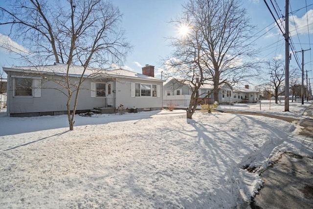 view of snow covered back of property