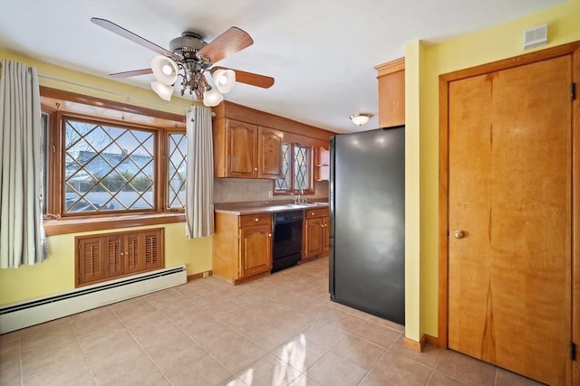 kitchen with sink, baseboard heating, refrigerator, backsplash, and black dishwasher