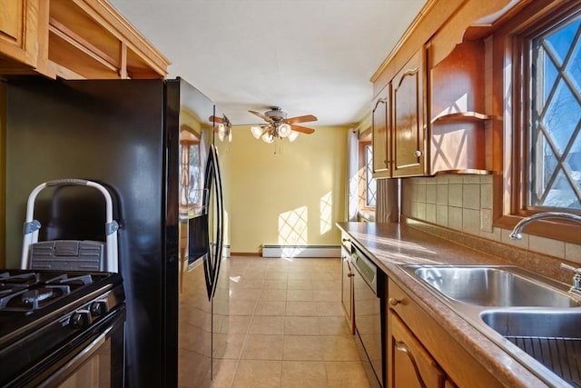 kitchen with sink, dishwasher, light tile patterned flooring, decorative backsplash, and a baseboard radiator