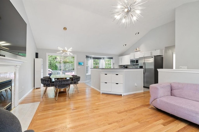 2 Pinebrook Ln, Worcester, MA 01609 - living area with a chandelier, light wood-style floors, high vaulted ceiling, a high end fireplace, and baseboards