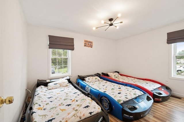 2 Pinebrook Ln, Worcester, MA 01609 - bedroom featuring multiple windows, wood finished floors, a chandelier, and baseboards