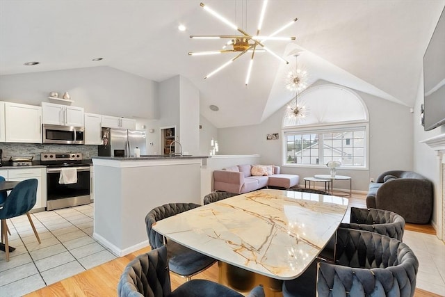 2 Pinebrook Ln, Worcester, MA 01609 - dining room with a chandelier, high vaulted ceiling, and light wood-style flooring