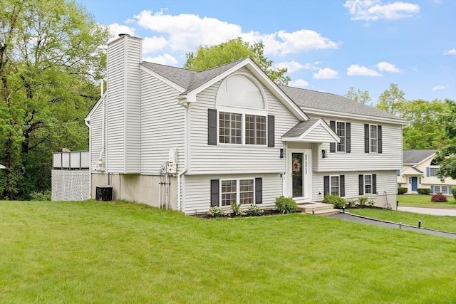 2 Pinebrook Ln, Worcester, MA 01609 - raised ranch with a chimney, a front yard, a shingled roof, and central AC unit