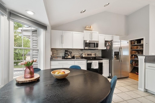 2 Pinebrook Ln, Worcester, MA 01609 - kitchen featuring appliances with stainless steel finishes, decorative backsplash, white cabinetry, light tile patterned floors, and dark countertops