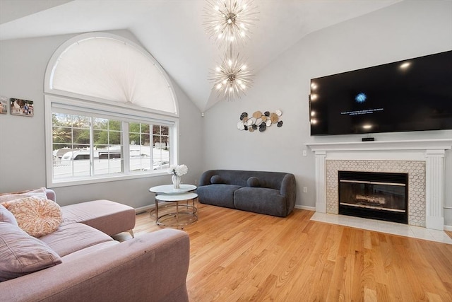 2 Pinebrook Ln, Worcester, MA 01609 - living area with lofted ceiling, light wood-style floors, a tile fireplace, and baseboards