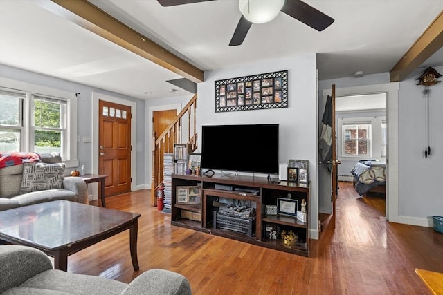 20 King St, Wilmington, MA 01887 - living room featuring beamed ceiling, stairway, a ceiling fan, wood finished floors, and a baseboard radiator