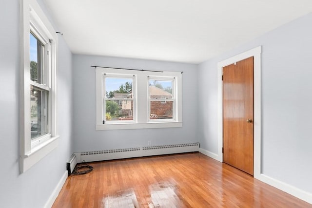 20 King St, Wilmington, MA 01887 - empty room with a baseboard heating unit and wood finished floors