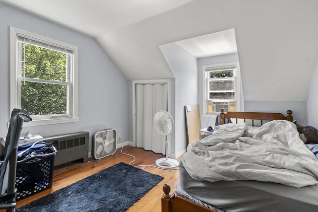 20 King St, Wilmington, MA 01887 - bedroom with lofted ceiling, wood finished floors, cooling unit, and radiator