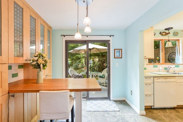 dining space with light tile patterned floors and sink