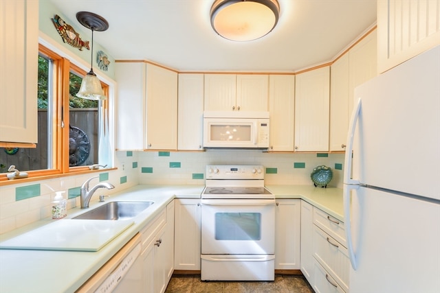 kitchen featuring decorative backsplash, white cabinets, pendant lighting, sink, and white appliances