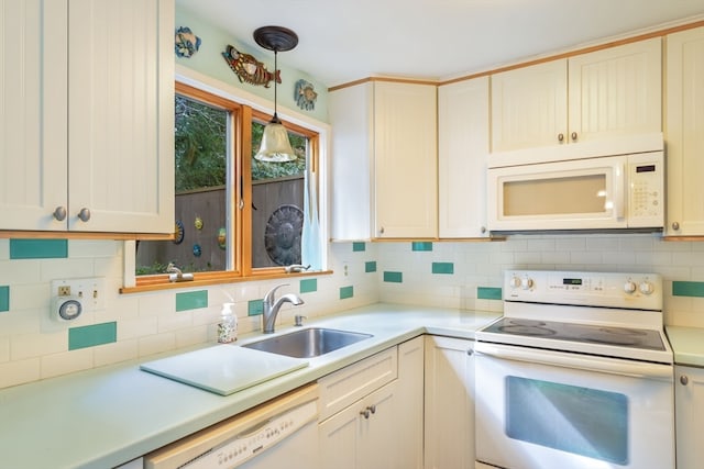 kitchen featuring sink, pendant lighting, white appliances, and tasteful backsplash