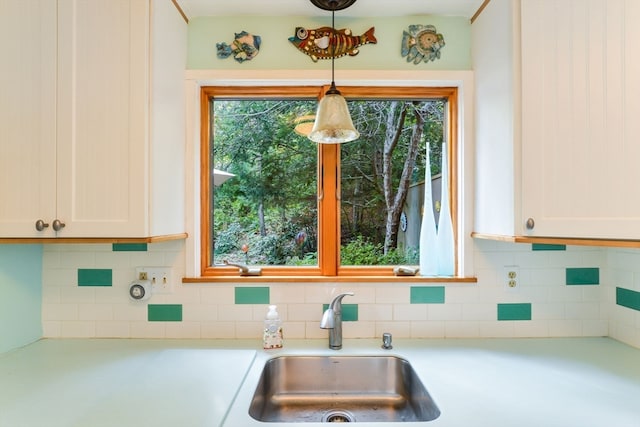 kitchen with white cabinetry, a healthy amount of sunlight, and sink