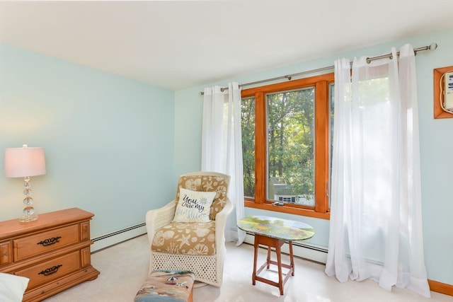 sitting room featuring baseboard heating and light colored carpet