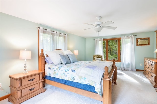 carpeted bedroom featuring a baseboard heating unit, an AC wall unit, and ceiling fan