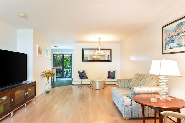 living room featuring a baseboard heating unit and hardwood / wood-style flooring